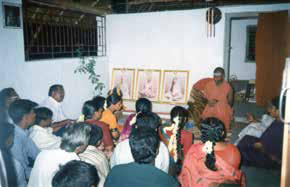 A devotee bows down in deep reverence to The SPH to receive His blessings